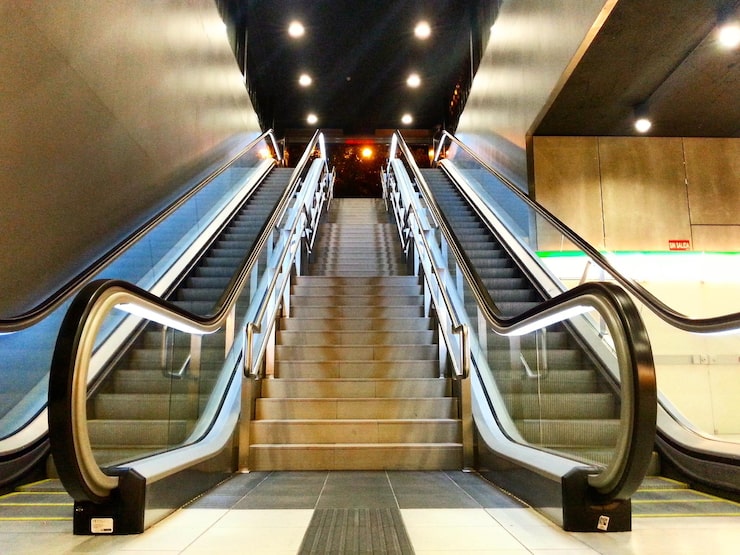 low-angle-view-escalators-illuminated-building_1048944-9126495